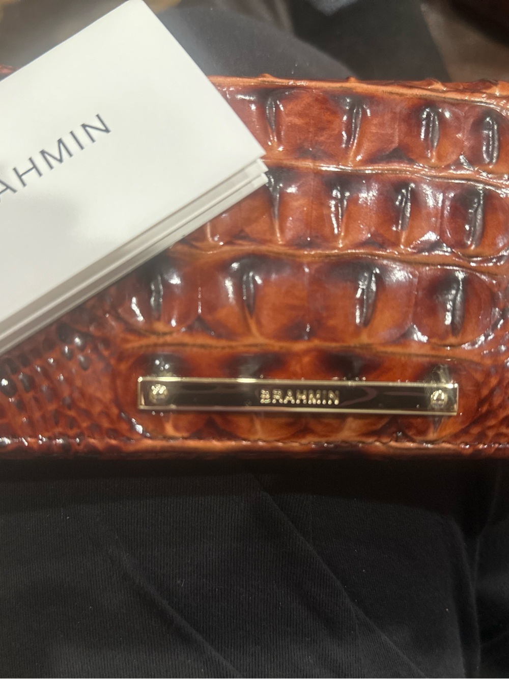 Brahmin glossy croc-embossed leather clutch in amber brown